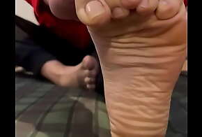 Guy doing yoga with soles view