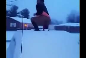 Crazy black girl fucking a dildo on a car roof in the snow